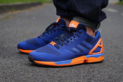 adidas orange and blue sneakers.